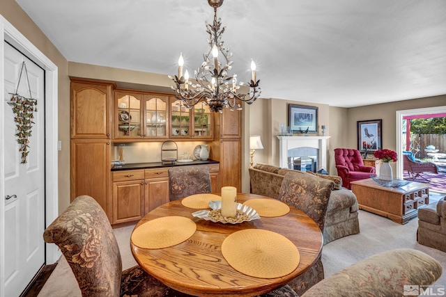 1509 Palo Verde, Carson City, NV 89703 - dining area featuring a glass covered fireplace, a chandelier, and light carpet