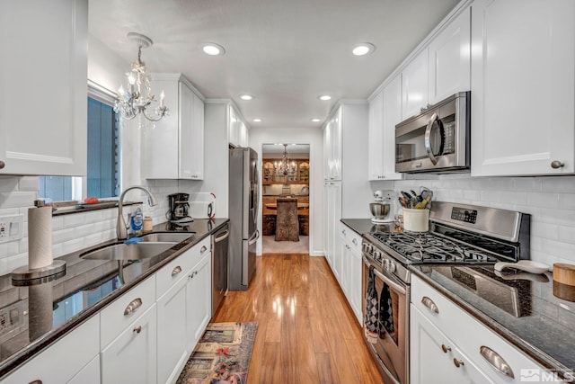 1509 Palo Verde, Carson City, NV 89703 - kitchen with stainless steel appliances, a sink, a chandelier, white cabinetry, and recessed lighting