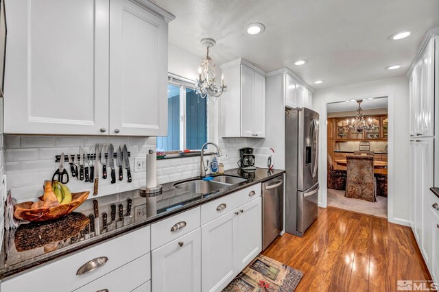 1509 Palo Verde, Carson City, NV 89703 - kitchen featuring a chandelier, appliances with stainless steel finishes, a sink, white cabinetry, and light wood-type flooring