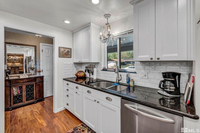 1509 Palo Verde, Carson City, NV 89703 - kitchen with stainless steel dishwasher, a sink, a chandelier, light wood-style flooring, and backsplash