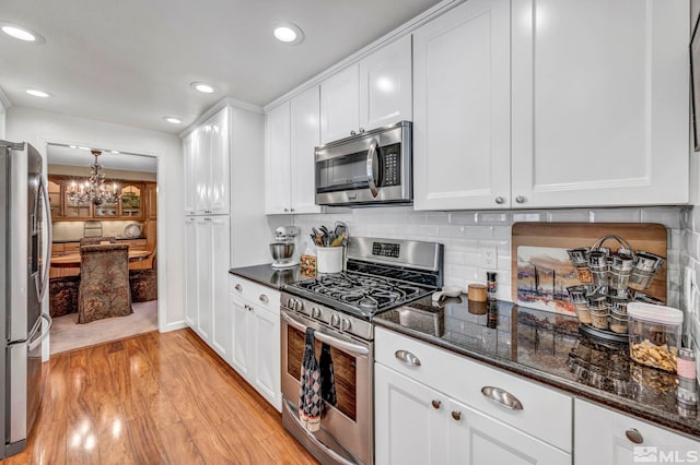 1509 Palo Verde, Carson City, NV 89703 - kitchen with appliances with stainless steel finishes, a chandelier, white cabinets, light wood-style floors, and recessed lighting