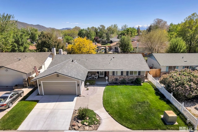 1509 Palo Verde, Carson City, NV 89703 - view of front of house with an attached garage, concrete driveway, roof with shingles, a mountain view, and a residential view