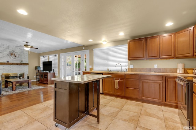 1874 Rosemary Dr, Sparks, NV 89434 - kitchen with appliances with stainless steel finishes, french doors, tile counters, ceiling fan, and a sink