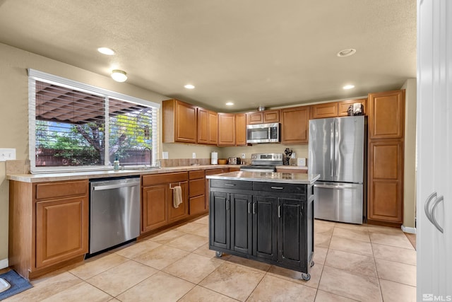 1874 Rosemary Dr, Sparks, NV 89434 - kitchen featuring stainless steel appliances, light countertops, recessed lighting, light tile patterned flooring, and a center island