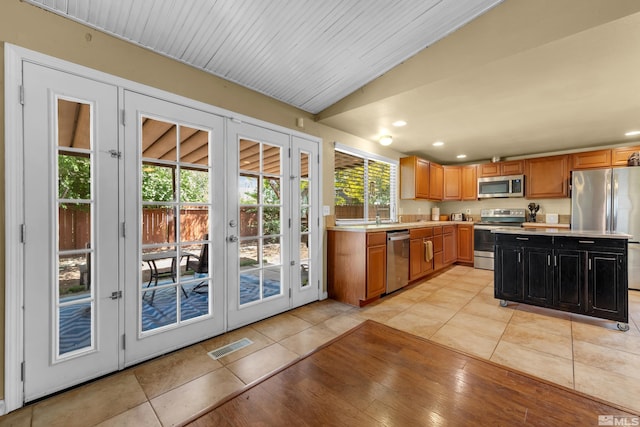 1874 Rosemary Dr, Sparks, NV 89434 - kitchen featuring appliances with stainless steel finishes, french doors, light countertops, light tile patterned floors, and recessed lighting