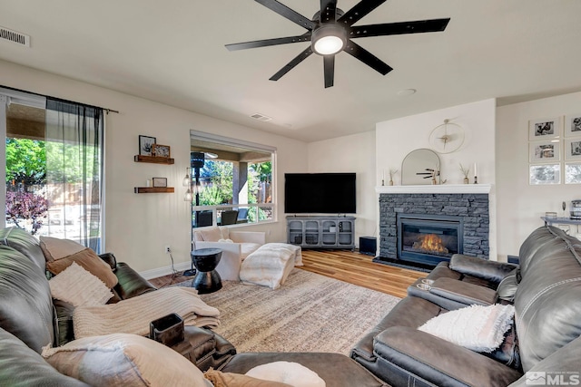 4184 Passage Dr, Sparks, NV 89436 - living area with plenty of natural light, a ceiling fan, wood finished floors, and a fireplace