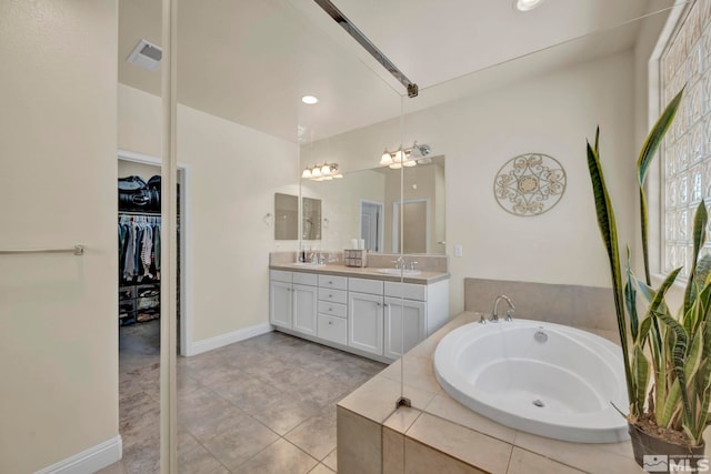 4184 Passage Dr, Sparks, NV 89436 - bathroom featuring double vanity, a garden tub, a walk in closet, tile patterned floors, and recessed lighting
