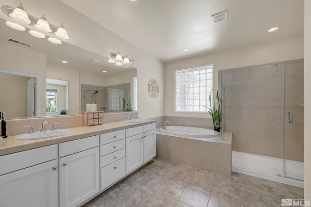 4184 Passage Dr, Sparks, NV 89436 - full bath featuring healthy amount of natural light, a shower stall, a garden tub, double vanity, and recessed lighting