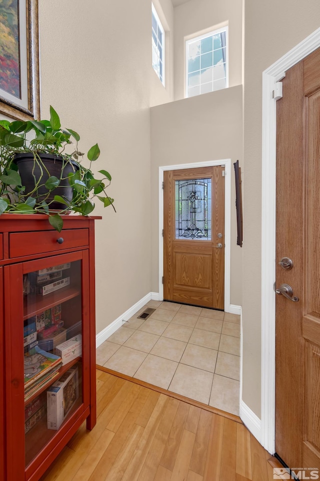 785 Sarcinella Ct, Reno, NV 89509 - entryway featuring baseboards, light wood finished floors, and a high ceiling