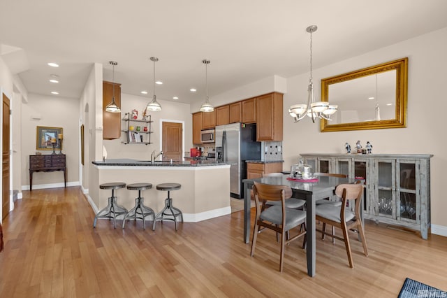 785 Sarcinella Ct, Reno, NV 89509 - dining room featuring a chandelier, light wood-style floors, recessed lighting, and baseboards