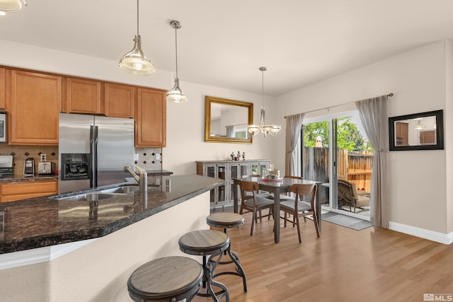 785 Sarcinella Ct, Reno, NV 89509 - kitchen with stainless steel fridge, a sink, decorative backsplash, and light wood finished floors