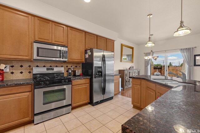 785 Sarcinella Ct, Reno, NV 89509 - kitchen featuring appliances with stainless steel finishes, tasteful backsplash, light tile patterned floors, and pendant lighting