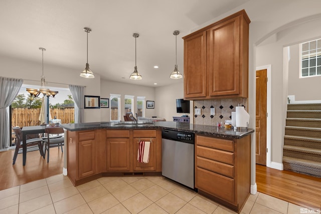 785 Sarcinella Ct, Reno, NV 89509 - kitchen with dishwasher, a sink, a peninsula, brown cabinets, and light tile patterned floors