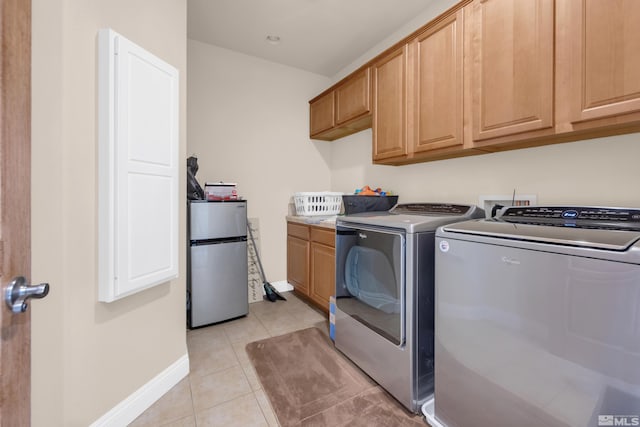 785 Sarcinella Ct, Reno, NV 89509 - clothes washing area with washing machine and clothes dryer, cabinet space, light tile patterned floors, and baseboards