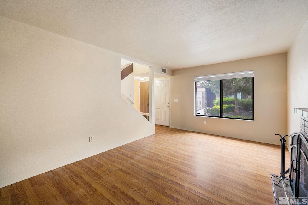 4545 Reggie Rd, Reno, NV 89502 - unfurnished living room featuring light wood-style floors and stairway