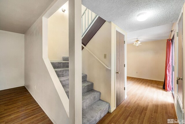 4545 Reggie Rd, Reno, NV 89502 - staircase featuring wood finished floors and a textured ceiling