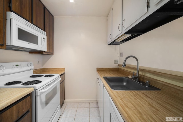 4545 Reggie Rd, Reno, NV 89502 - kitchen with white appliances, a sink, baseboards, wood counters, and light tile patterned floors