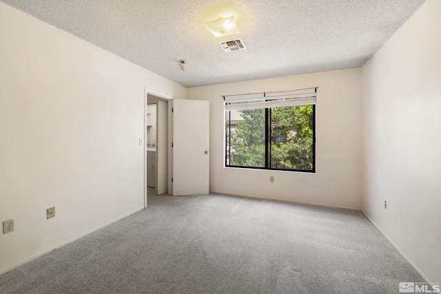 4545 Reggie Rd, Reno, NV 89502 - carpeted spare room featuring a textured ceiling, washer / clothes dryer, and baseboards