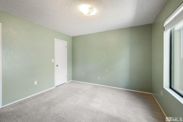 4545 Reggie Rd, Reno, NV 89502 - empty room featuring carpet flooring, a textured ceiling, and baseboards