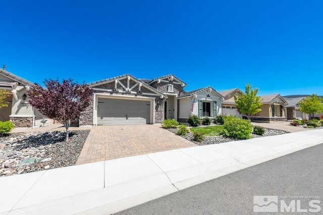9680 Thesolious Ln, Reno, NV 89521 - view of front facade featuring an attached garage, decorative driveway, and stone siding
