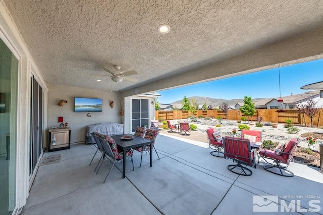 9680 Thesolious Ln, Reno, NV 89521 - view of patio with outdoor dining space, a fenced backyard, and a ceiling fan