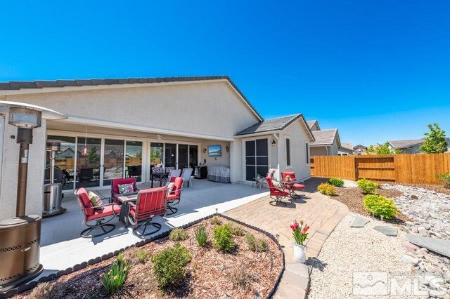 9680 Thesolious Ln, Reno, NV 89521 - back of property with fence, a patio, and stucco siding