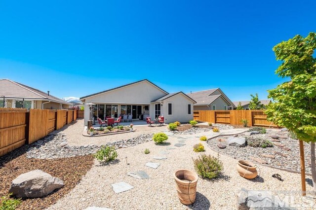 9680 Thesolious Ln, Reno, NV 89521 - back of house featuring a patio and a fenced backyard
