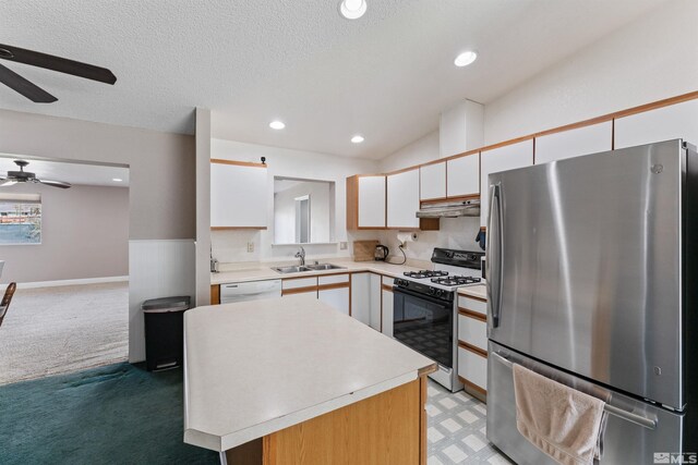 1380 Patricia Dr, Gardnerville, NV 89460 - kitchen with freestanding refrigerator, gas range oven, a ceiling fan, a sink, and under cabinet range hood