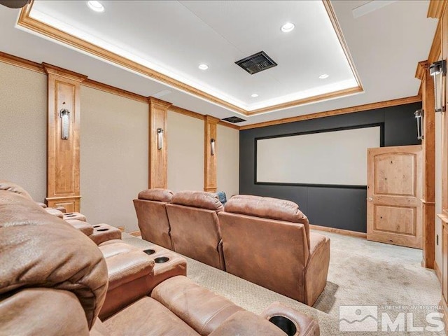 home theater room featuring a raised ceiling, light colored carpet, crown molding, and recessed lighting