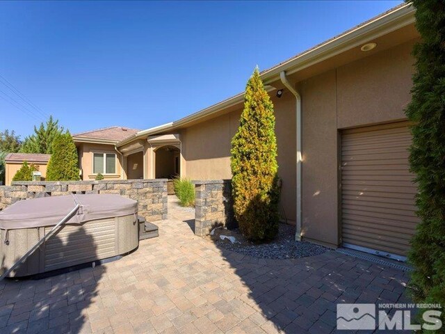 view of patio / terrace featuring a hot tub