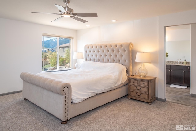 8139 Dornoch Dr, Reno, NV 89439 - bedroom featuring a sink, light carpet, baseboards, ensuite bath, and ceiling fan