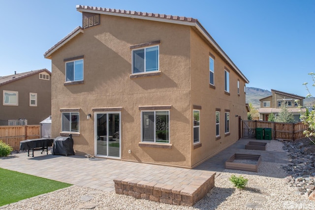 8139 Dornoch Dr, Reno, NV 89439 - back of house featuring a patio, stucco siding, and fence