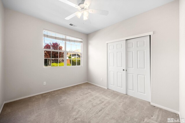 unfurnished bedroom featuring carpet, baseboards, and a closet