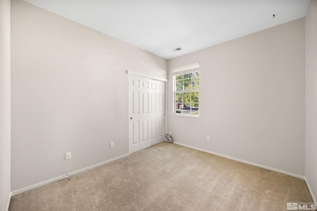 unfurnished bedroom with carpet floors, baseboards, and a closet