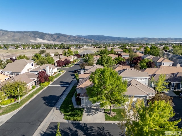 aerial view of residential area featuring mountains