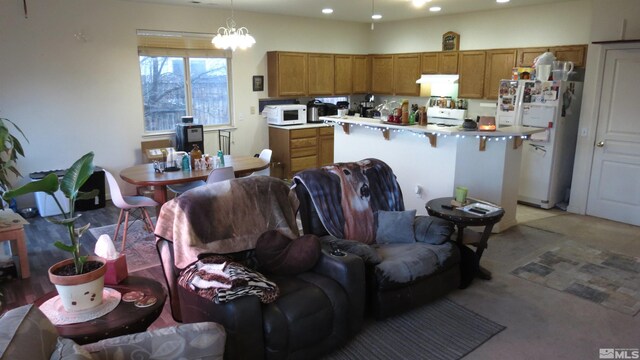201 Crown Point Dr, Dayton, NV 89403 - kitchen featuring white appliances, brown cabinets, a kitchen island, recessed lighting, and light countertops