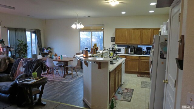 201 Crown Point Dr, Dayton, NV 89403 - kitchen featuring white appliances, brown cabinetry, healthy amount of natural light, open floor plan, and recessed lighting