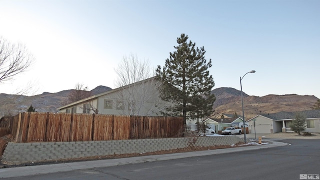 201 Crown Point Dr, Dayton, NV 89403 - view of property exterior with fence, a mountain view, and a garage