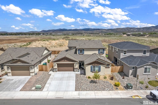103 Pilot Peak, Carson City, NV 89701 - traditional-style house featuring fence, a mountain view, concrete driveway, and an attached garage