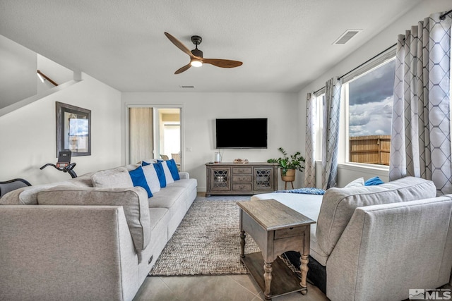 103 Pilot Peak, Carson City, NV 89701 - living area featuring a ceiling fan, a textured ceiling, and tile patterned flooring