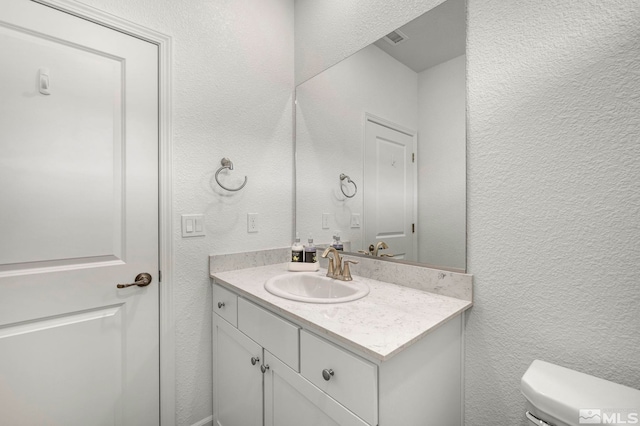 103 Pilot Peak, Carson City, NV 89701 - half bath featuring a textured wall, vanity, and toilet