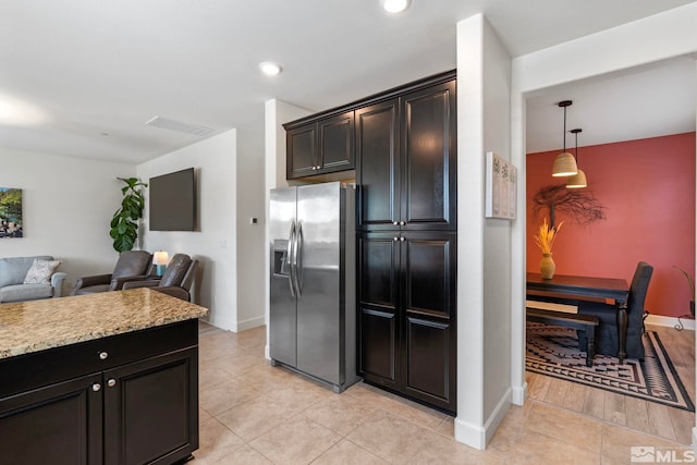 3097 Livorno Dr, Sparks, NV 89434 - kitchen featuring stainless steel refrigerator with ice dispenser, open floor plan, baseboards, recessed lighting, and light tile patterned floors