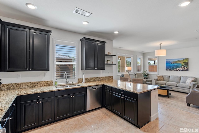3097 Livorno Dr, Sparks, NV 89434 - kitchen featuring a sink, dishwasher, dark cabinets, a peninsula, and open floor plan