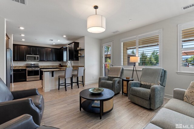3097 Livorno Dr, Sparks, NV 89434 - living room featuring light wood-style flooring, baseboards, and recessed lighting