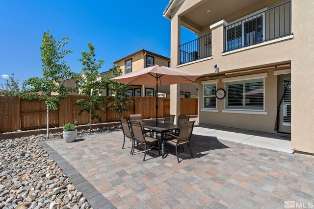3097 Livorno Dr, Sparks, NV 89434 - view of patio / terrace featuring fence, a balcony, and outdoor dining space