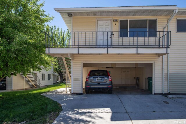 745 Jamaica Ave Unit 4, Reno, NV 89502 - view of front facade featuring driveway, stairs, a balcony, and a garage