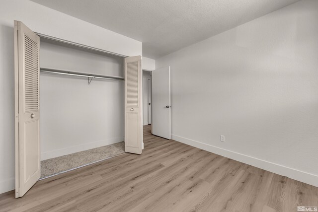745 Jamaica Ave Unit 4, Reno, NV 89502 - unfurnished bedroom featuring wood finished floors, a closet, and baseboards