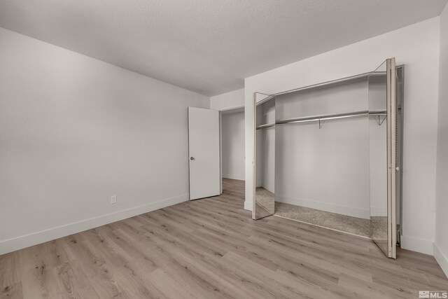 745 Jamaica Ave Unit 4, Reno, NV 89502 - unfurnished bedroom with wood finished floors, baseboards, and a closet
