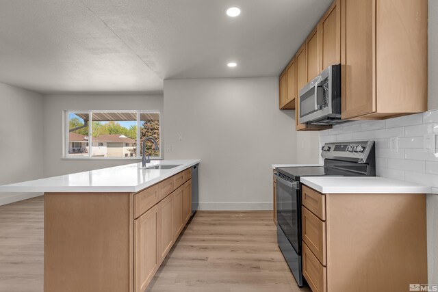 745 Jamaica Ave Unit 4, Reno, NV 89502 - kitchen with appliances with stainless steel finishes, a peninsula, a sink, baseboards, and light wood-style flooring