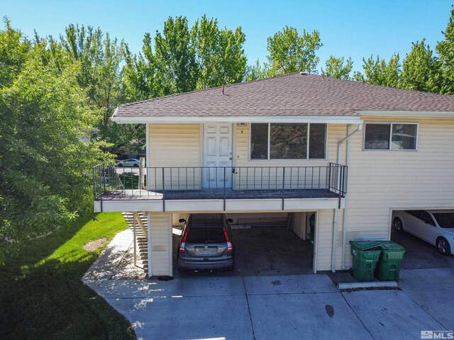 745 Jamaica Ave Unit 4, Reno, NV 89502 - view of front of house with concrete driveway, a shingled roof, and stairs